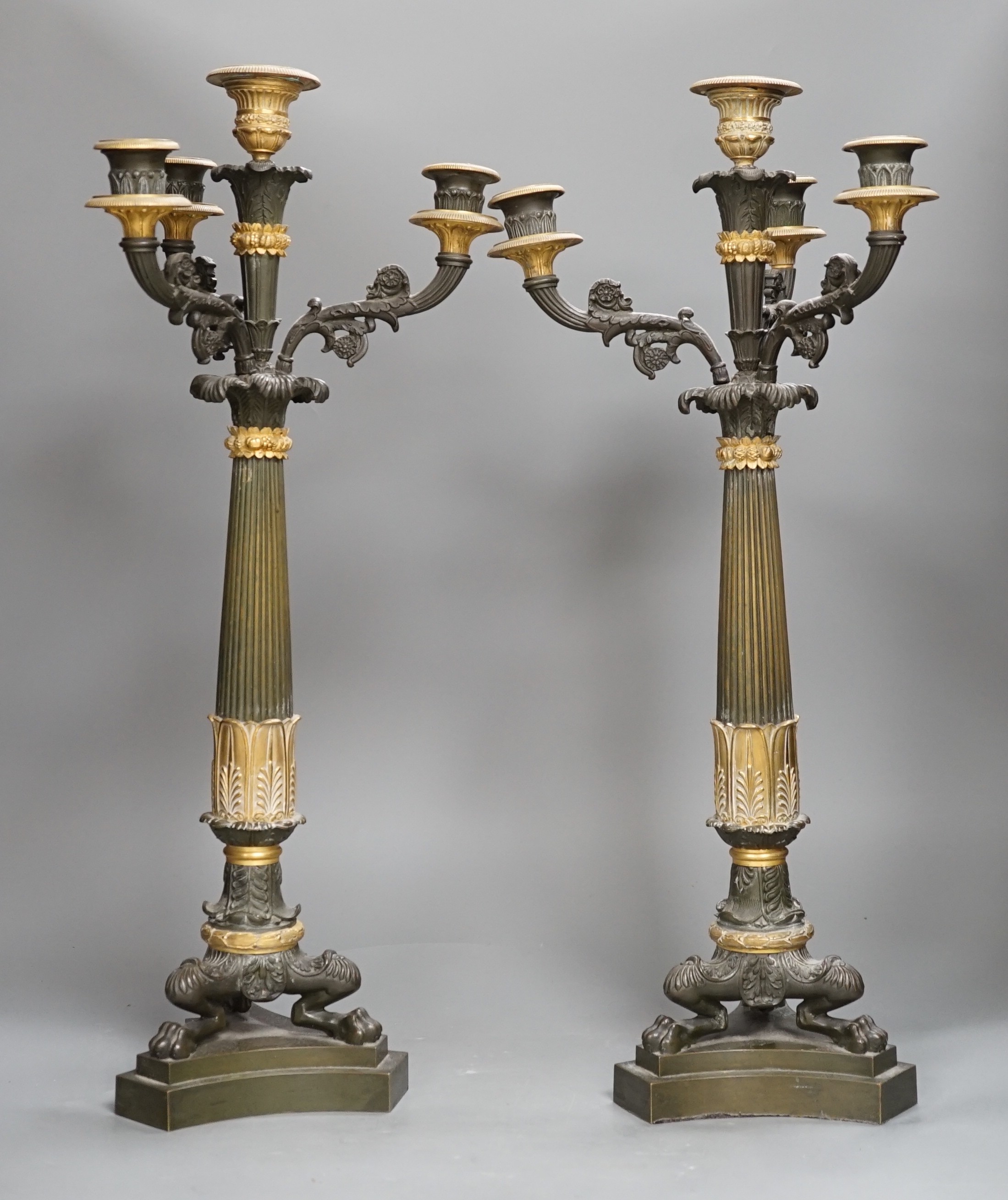 A pair of 19th century French Empire style bronze and gilt metal three branch, four light candelabra, 54cms high